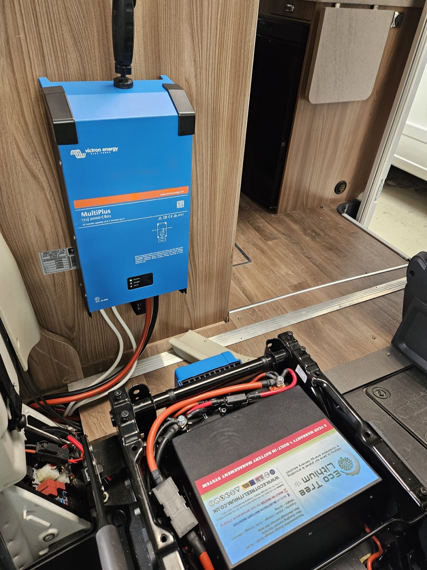 Victron MultiPlus installed inside a motorhome alongside a lithium battery